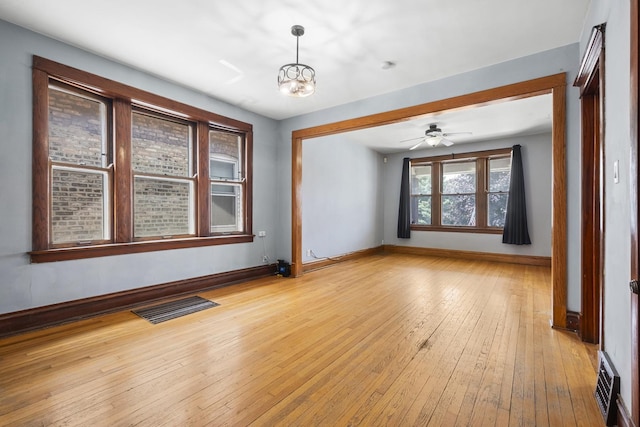 2219 S 60th Ct, Cicero, IL 60804 - unfurnished room featuring light wood-style floors, ceiling fan, and a chandelier