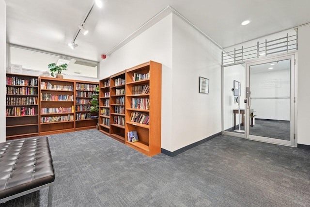 4800 S Chicago Beach Dr Unit 702S, Chicago, IL 60615 - sitting room featuring dark carpet, bookshelves, and track lighting
