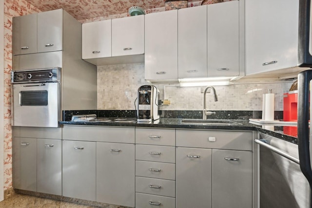 4800 S Chicago Beach Dr Unit 702S, Chicago, IL 60615 - kitchen featuring oven, stainless steel dishwasher, dark stone counters, tasteful backsplash, and stovetop