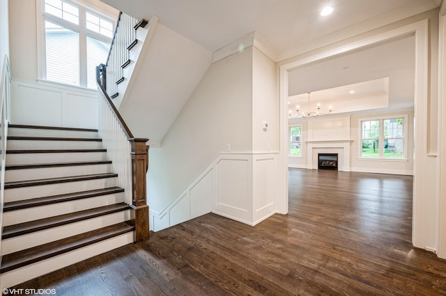 5903 Timber Trails Blvd, Western Springs, IL 60558 - staircase with wood finished floors, a chandelier, a decorative wall, wainscoting, and a raised ceiling