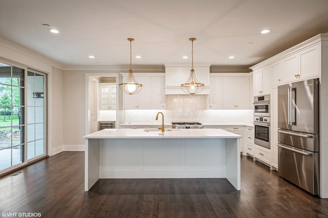 5903 Timber Trails Blvd, Western Springs, IL 60558 - kitchen with appliances with stainless steel finishes, light countertops, decorative backsplash, dark wood finished floors, and a center island with sink