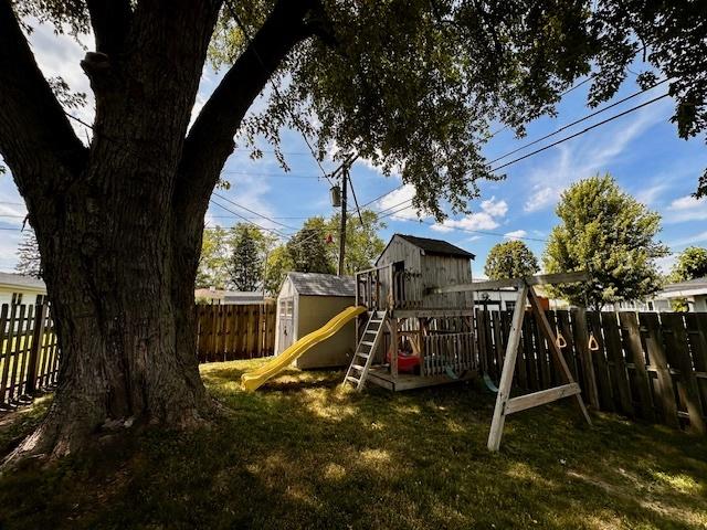 1700 Sunset Dr, Mendota, IL 61342 - view of jungle gym with a fenced backyard and a storage shed