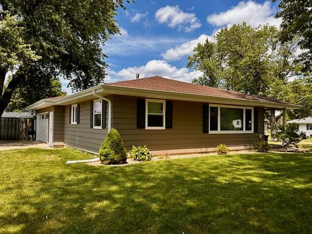 1700 Sunset Dr, Mendota, IL 61342 - view of side of home with a lawn and an attached garage