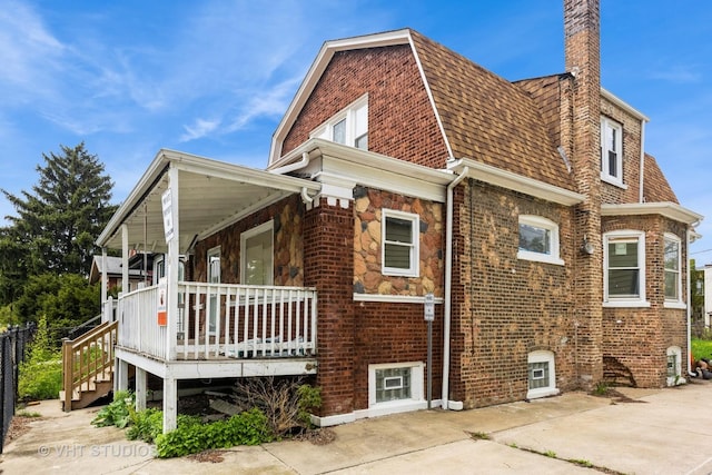 32 W 109th Pl, Chicago, IL 60628 - view of home's exterior featuring brick siding, covered porch, a chimney, and roof with shingles