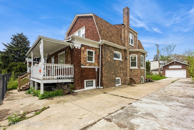 32 W 109th Pl, Chicago, IL 60628 - view of side of home featuring covered porch, a garage, an outdoor structure, a chimney, and roof with shingles