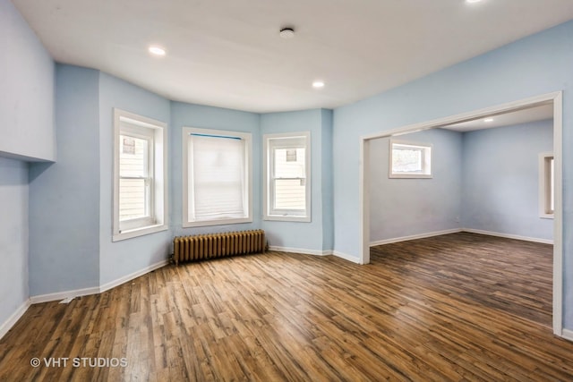 32 W 109th Pl, Chicago, IL 60628 - unfurnished living room with radiator heating unit, wood finished floors, and recessed lighting