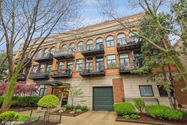 920 W Sheridan Rd Unit 305, Chicago, IL 60613 - view of front facade with a balcony, an attached garage, and driveway