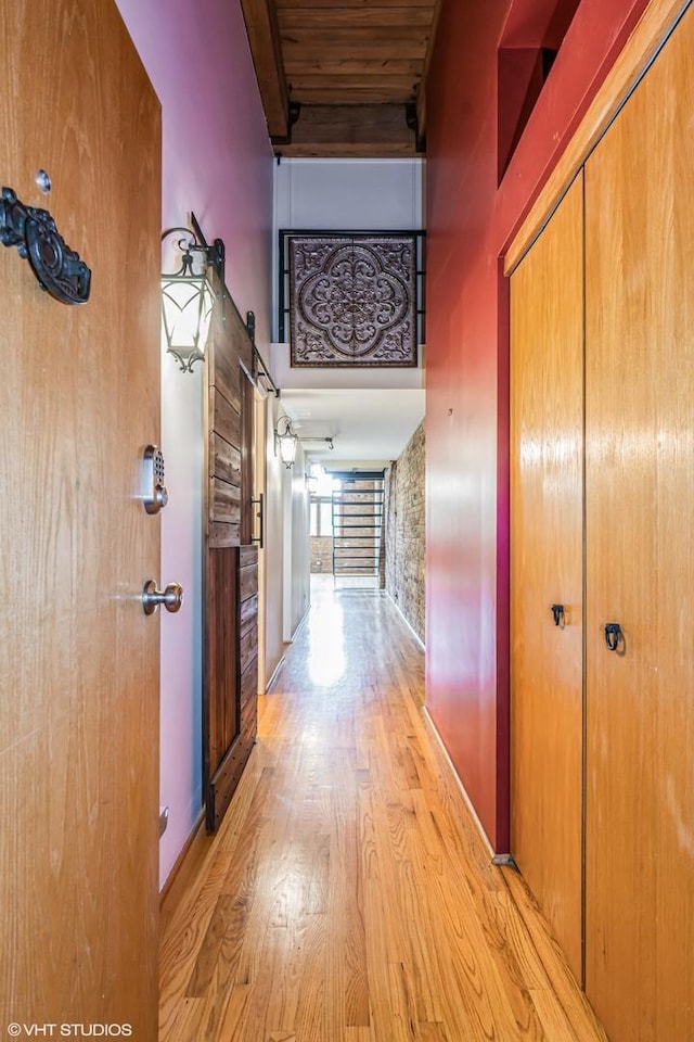 920 W Sheridan Rd Unit 305, Chicago, IL 60613 - hall featuring light wood finished floors, a barn door, and a high ceiling