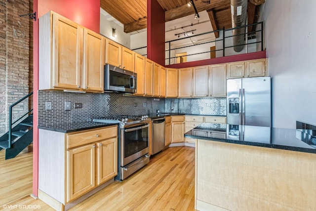 920 W Sheridan Rd Unit 305, Chicago, IL 60613 - kitchen with appliances with stainless steel finishes, light wood finished floors, a wood ceiling with exposed beams, light brown cabinets, and decorative backsplash