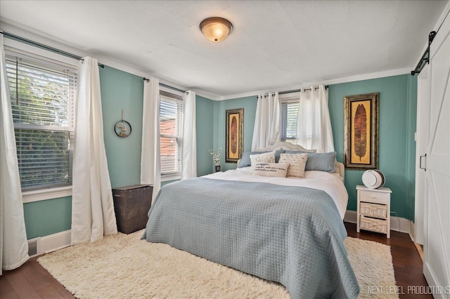 704 Cedar Ave, Saint Charles, IL 60174 - bedroom with dark wood-type flooring, a barn door, and ornamental molding