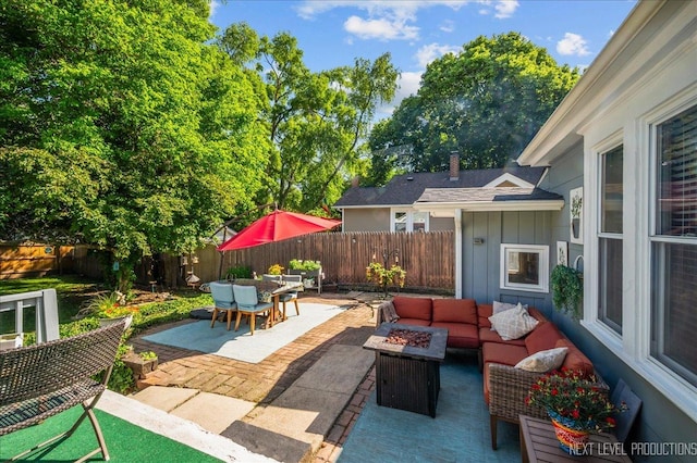 704 Cedar Ave, Saint Charles, IL 60174 - fenced backyard with a patio area, an outdoor living space with a fire pit, and outdoor dining space