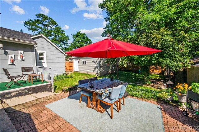 704 Cedar Ave, Saint Charles, IL 60174 - fenced backyard featuring outdoor dining area, a patio, and a storage shed