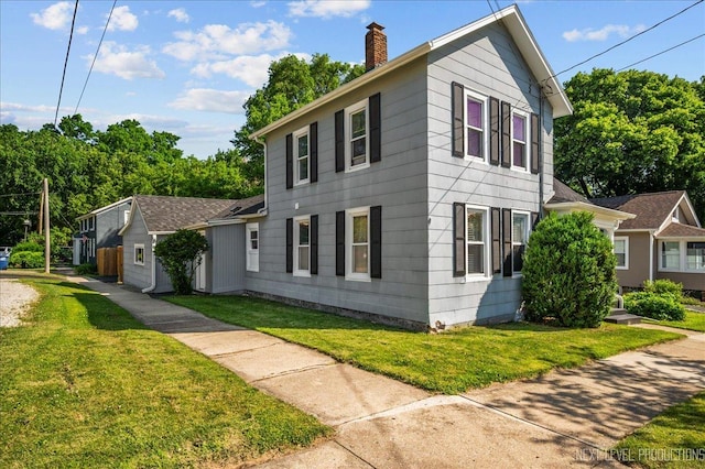 704 Cedar Ave, Saint Charles, IL 60174 - colonial house with a chimney and a front lawn