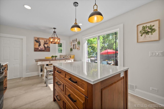 704 Cedar Ave, Saint Charles, IL 60174 - kitchen featuring brown cabinets, light countertops, pendant lighting, a chandelier, and recessed lighting