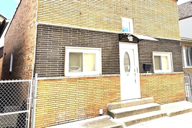 2947 S Farrell St, Chicago, IL 60608 - view of exterior entry featuring brick siding and a gate