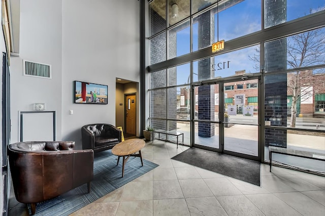 1122 W Catalpa Ave Unit 815, Chicago, IL 60640 - community lobby featuring a high ceiling and a wall of windows