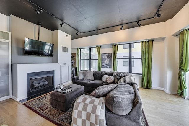 1122 W Catalpa Ave Unit 815, Chicago, IL 60640 - living room with track lighting, light wood-type flooring, and a fireplace