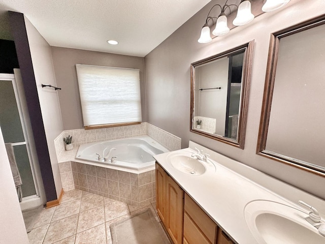 597 Barry Turn, Manteno, IL 60950 - bathroom with a bath, double vanity, tile patterned floors, and a textured ceiling