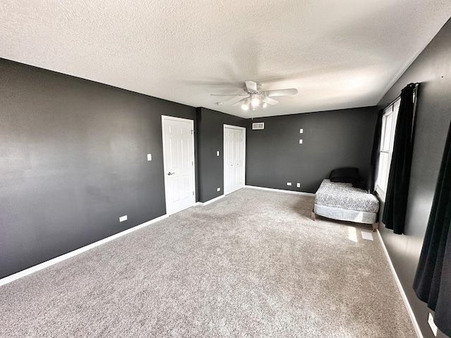 597 Barry Turn, Manteno, IL 60950 - unfurnished bedroom with a textured ceiling, carpet flooring, and ceiling fan