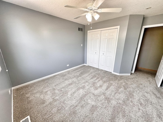 597 Barry Turn, Manteno, IL 60950 - unfurnished bedroom featuring a textured ceiling, a closet, carpet, and a ceiling fan