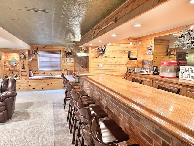 597 Barry Turn, Manteno, IL 60950 - indoor dry bar featuring wood walls and carpet floors