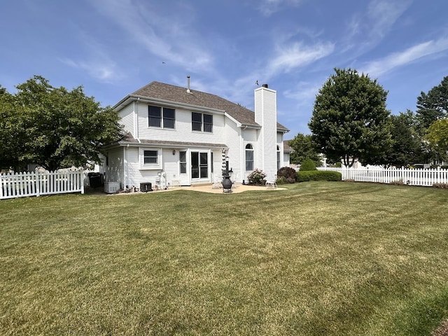 597 Barry Turn, Manteno, IL 60950 - rear view of house with a chimney, a fenced backyard, and a patio area