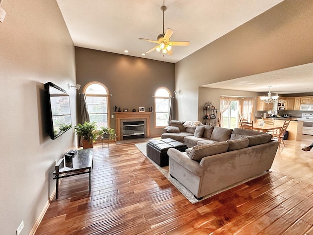 597 Barry Turn, Manteno, IL 60950 - living area featuring light wood finished floors, healthy amount of natural light, a towering ceiling, a ceiling fan, and a chandelier