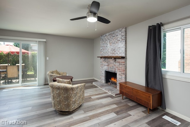 6665 Foxtree Ave, Woodridge, IL 60517 - living area with a fireplace, plenty of natural light, a ceiling fan, and wood finished floors