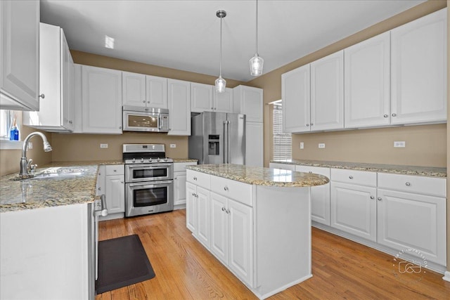 3210 Larrabee Dr, Geneva, IL 60134 - kitchen with appliances with stainless steel finishes, light wood-style flooring, white cabinets, and a center island