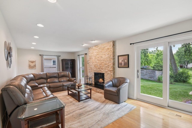 5085 Dukesberry Ln, Hoffman Estates, IL 60010 - living area with light wood-type flooring, a stone fireplace, and recessed lighting