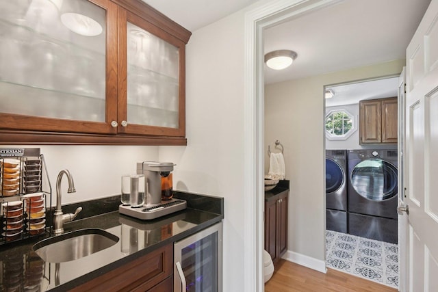 5085 Dukesberry Ln, Hoffman Estates, IL 60010 - indoor wet bar featuring beverage cooler, washer and dryer, and light wood-type flooring