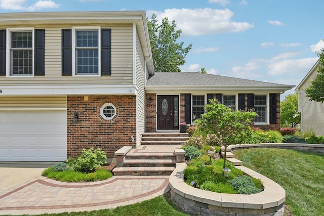 5085 Dukesberry Ln, Hoffman Estates, IL 60010 - view of front facade with brick siding, an attached garage, a front lawn, and concrete driveway