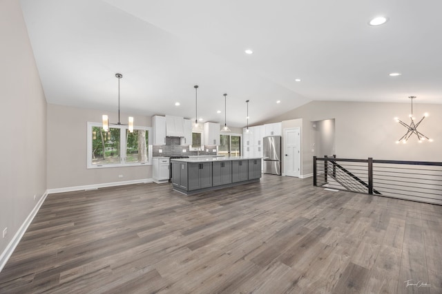 9704 Captains Dr, Algonquin, IL 60102 - kitchen with freestanding refrigerator, lofted ceiling, a chandelier, white cabinets, and gray cabinets
