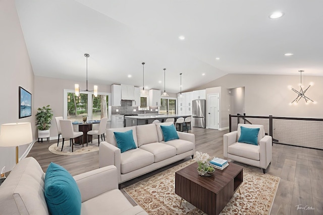9704 Captains Dr, Algonquin, IL 60102 - living room featuring a chandelier, lofted ceiling, light wood-style flooring, and recessed lighting