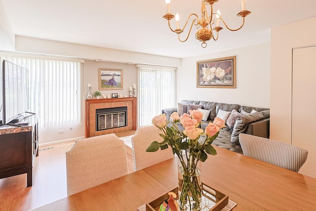 377 Grissom Ct, Hoffman Estates, IL 60169 - dining room featuring a chandelier, wood finished floors, and a tiled fireplace