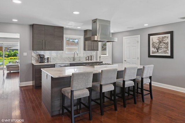 2721 Joseph Ave, Des Plaines, IL 60018 - kitchen with range hood, a kitchen bar, dark wood-style flooring, backsplash, and stainless steel appliances