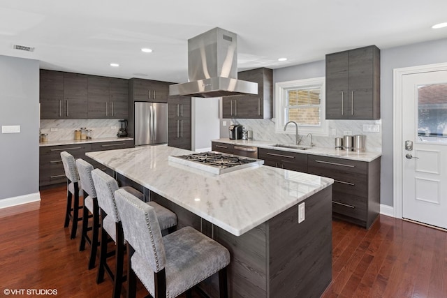 2721 Joseph Ave, Des Plaines, IL 60018 - kitchen with stainless steel appliances, island exhaust hood, a breakfast bar, decorative backsplash, and a kitchen island