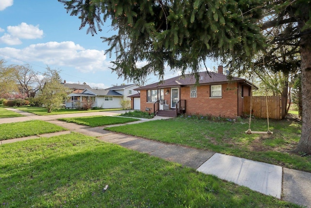 2023 Kristan Ave, North Chicago, IL 60064 - view of front facade with brick siding, a chimney, a garage, and concrete driveway