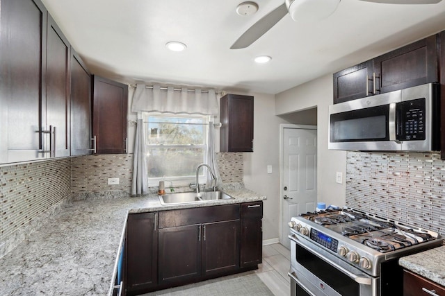 2023 Kristan Ave, North Chicago, IL 60064 - kitchen featuring appliances with stainless steel finishes, tasteful backsplash, dark brown cabinetry, and recessed lighting