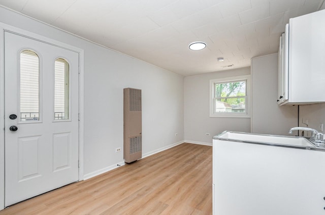 208 Webster Ln, Schaumburg, IL 60193 - laundry area with a heating unit and light wood finished floors