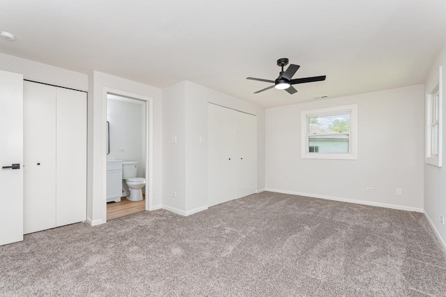 208 Webster Ln, Schaumburg, IL 60193 - unfurnished bedroom with carpet flooring, multiple closets, ensuite bathroom, and a ceiling fan