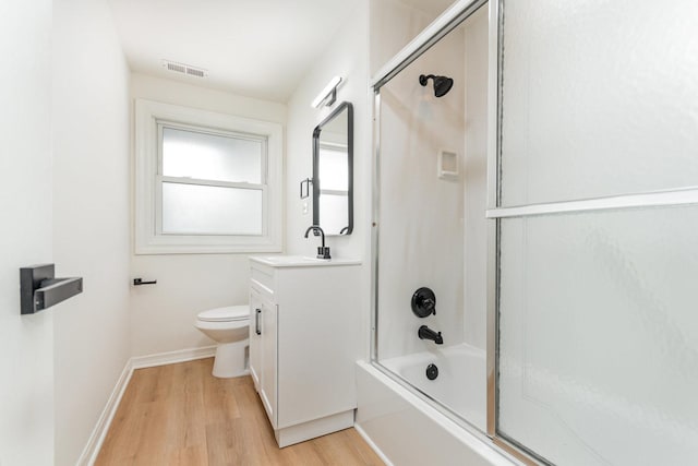 208 Webster Ln, Schaumburg, IL 60193 - bathroom featuring vanity, wood finished floors, and bath / shower combo with glass door