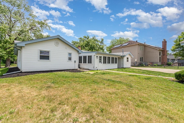 208 Webster Ln, Schaumburg, IL 60193 - rear view of property featuring a sunroom and a chimney