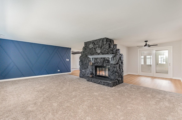 208 Webster Ln, Schaumburg, IL 60193 - unfurnished living room with light carpet, a ceiling fan, and a stone fireplace