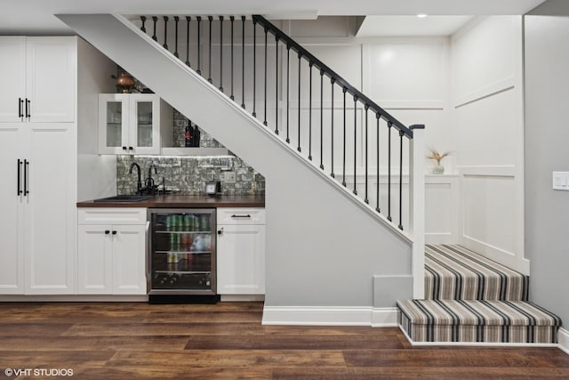 3444 N Hamilton Ave, Chicago, IL 60618 - indoor wet bar with wine cooler, dark wood finished floors, stairway, and backsplash