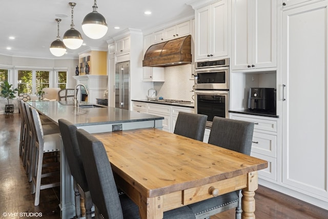 3444 N Hamilton Ave, Chicago, IL 60618 - dining area featuring crown molding, recessed lighting, dark wood-style flooring, and a lit fireplace
