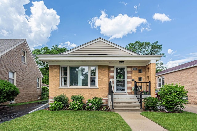 9226 S Utica Ave, Evergreen Park, IL 60805 - view of front of property featuring a front yard, brick siding, and covered porch