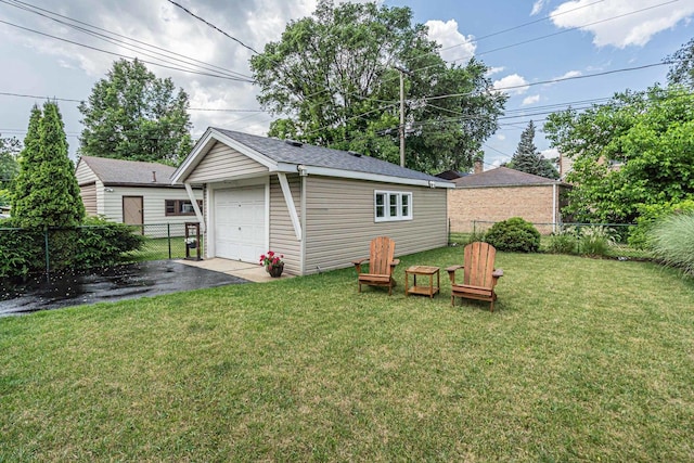 9226 S Utica Ave, Evergreen Park, IL 60805 - back of house featuring an outbuilding, a garage, and asphalt driveway