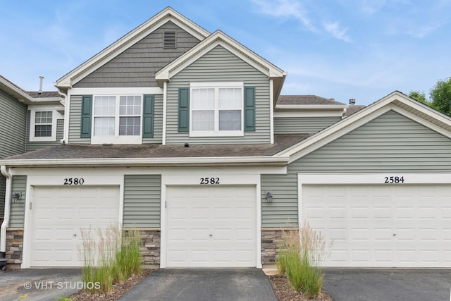 2582 Golf Ridge Cir, Naperville, IL 60563 - view of front facade with stone siding, asphalt driveway, and roof with shingles