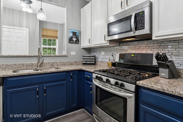 2582 Golf Ridge Cir, Naperville, IL 60563 - kitchen with appliances with stainless steel finishes, blue cabinets, white cabinetry, decorative backsplash, and wood finished floors